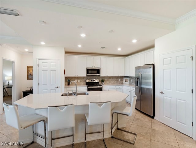 kitchen featuring appliances with stainless steel finishes, white cabinetry, and sink