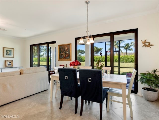 tiled dining space featuring an inviting chandelier, plenty of natural light, and ornamental molding