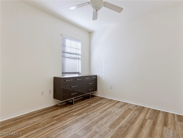 spare room featuring ceiling fan and light hardwood / wood-style flooring