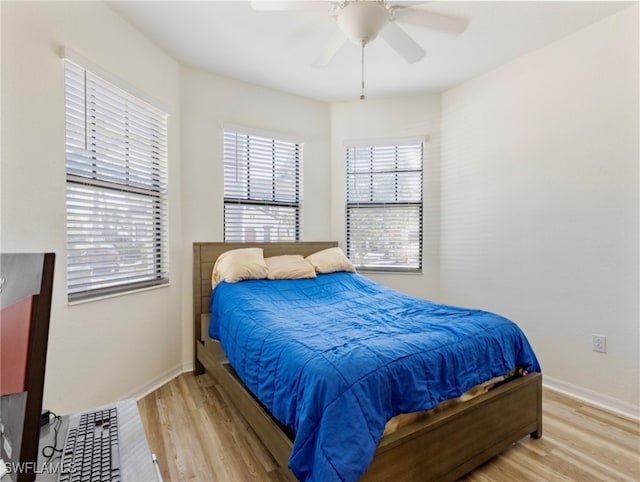 bedroom with ceiling fan and wood-type flooring