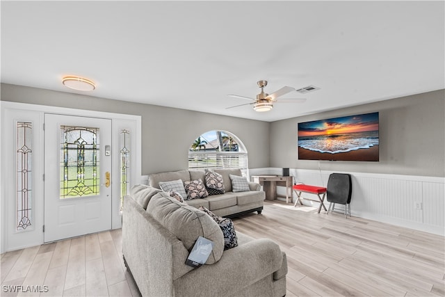 living room with ceiling fan and light wood-type flooring