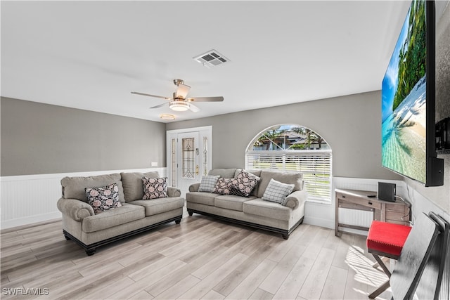 living room with ceiling fan and light wood-type flooring