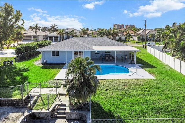 view of swimming pool featuring a yard and a patio