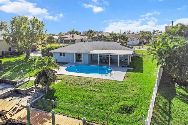 view of swimming pool featuring a lawn and a patio area