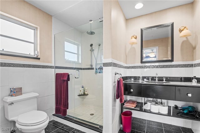 bathroom with walk in shower, vanity, tile walls, tile patterned flooring, and toilet