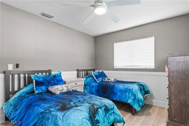 bedroom with ceiling fan and light hardwood / wood-style flooring