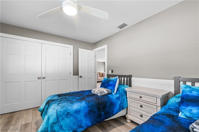 bedroom featuring a closet, light hardwood / wood-style floors, and ceiling fan