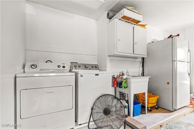 laundry area featuring cabinets and washing machine and dryer