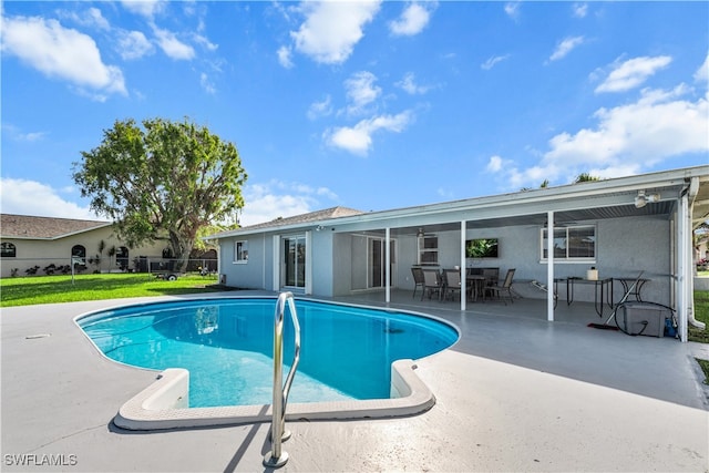 view of swimming pool featuring a lawn and a patio