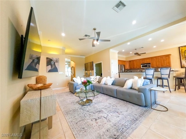 tiled living room featuring crown molding and ceiling fan