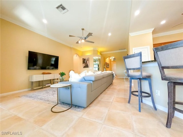 living room with ceiling fan, light tile patterned flooring, and ornamental molding