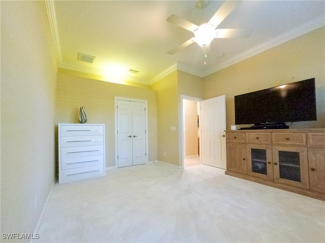 unfurnished living room featuring light colored carpet, ceiling fan, and ornamental molding