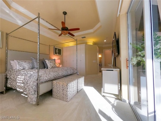 carpeted bedroom with ceiling fan, crown molding, access to outside, and a tray ceiling