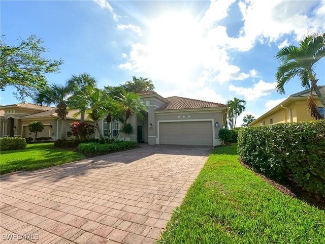 mediterranean / spanish-style house with a front yard and a garage