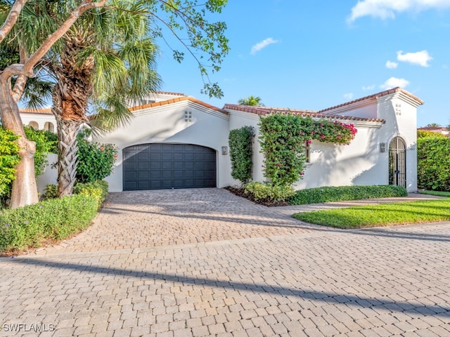 mediterranean / spanish-style house with a garage