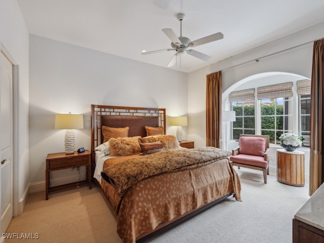 bedroom with light carpet and ceiling fan