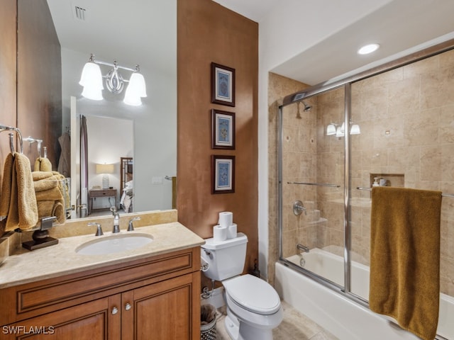 full bathroom with tile patterned flooring, vanity, bath / shower combo with glass door, and toilet