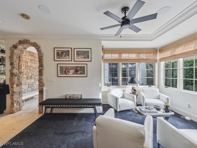 living room featuring ceiling fan and ornamental molding