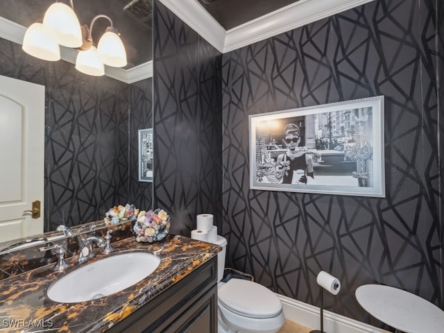 bathroom with vanity, toilet, ornamental molding, and a notable chandelier