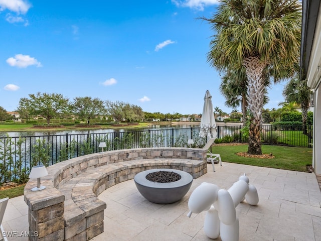 view of patio featuring a water view and an outdoor fire pit