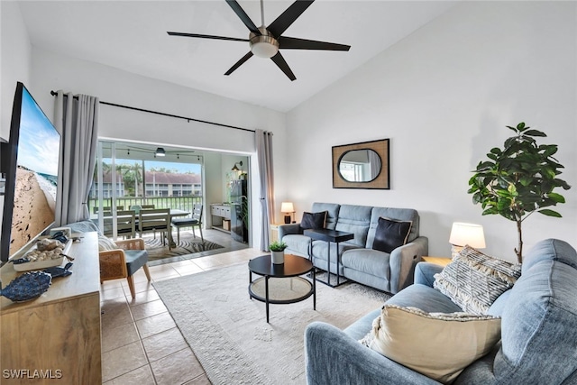 tiled living room featuring ceiling fan and high vaulted ceiling