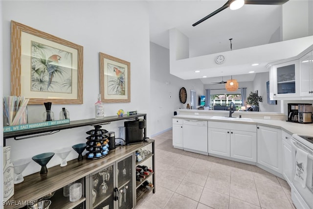 kitchen featuring pendant lighting, white appliances, sink, light tile patterned floors, and white cabinetry