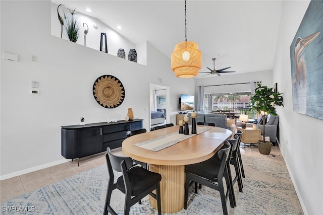 tiled dining area featuring high vaulted ceiling and ceiling fan