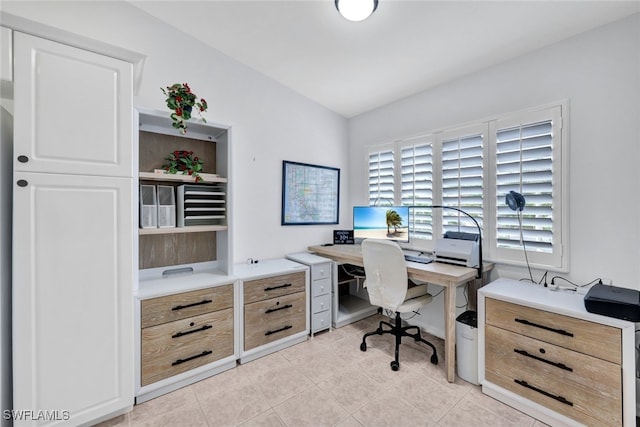 office space featuring light tile patterned flooring and lofted ceiling