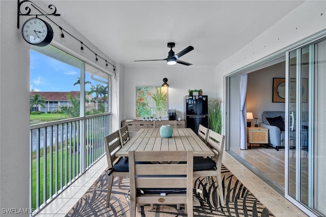 tiled dining space featuring ceiling fan