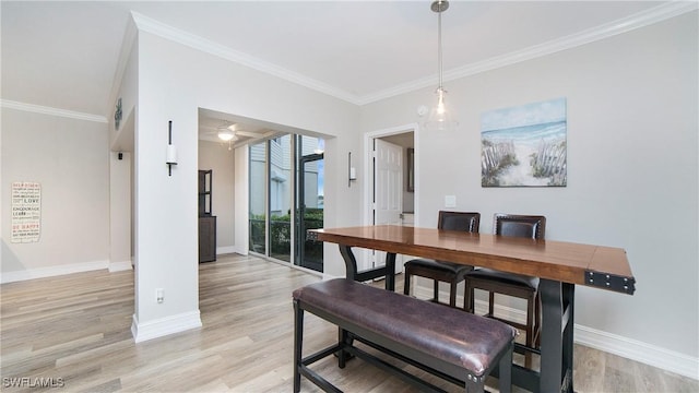 dining room with crown molding, light hardwood / wood-style floors, and ceiling fan