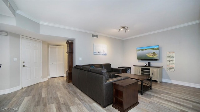 living room featuring crown molding and light hardwood / wood-style flooring