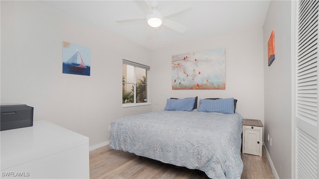 bedroom with ceiling fan and light hardwood / wood-style flooring