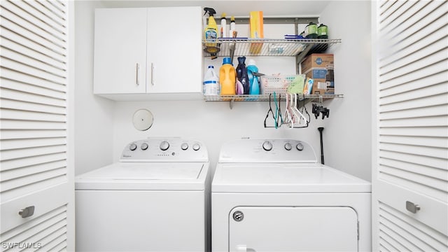 washroom featuring cabinets and washing machine and clothes dryer