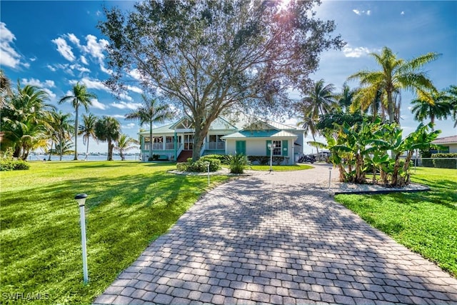 view of front of property featuring covered porch and a front yard