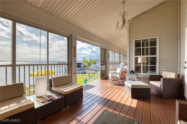 unfurnished sunroom with a water view, an inviting chandelier, lofted ceiling, and wood ceiling