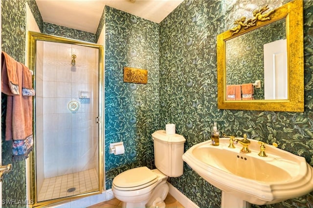 bathroom featuring tile patterned floors, sink, an enclosed shower, and toilet