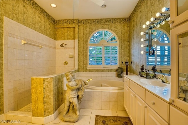 bathroom with tile patterned floors, vanity, separate shower and tub, and a wealth of natural light