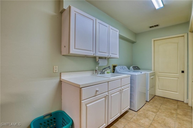 washroom with washer and clothes dryer, sink, and cabinets