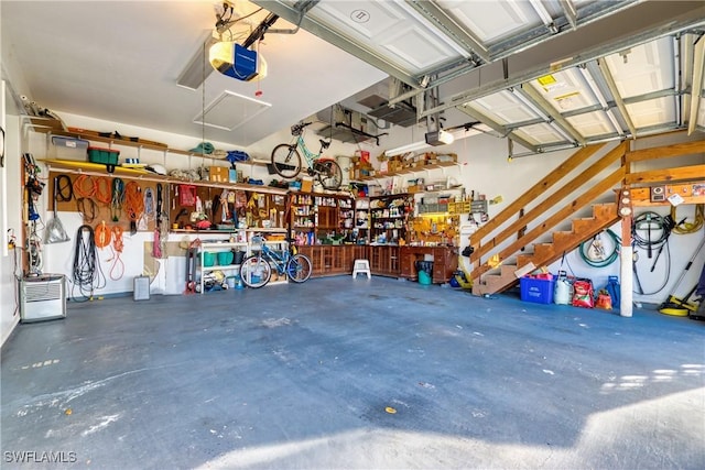 garage with a workshop area and a garage door opener