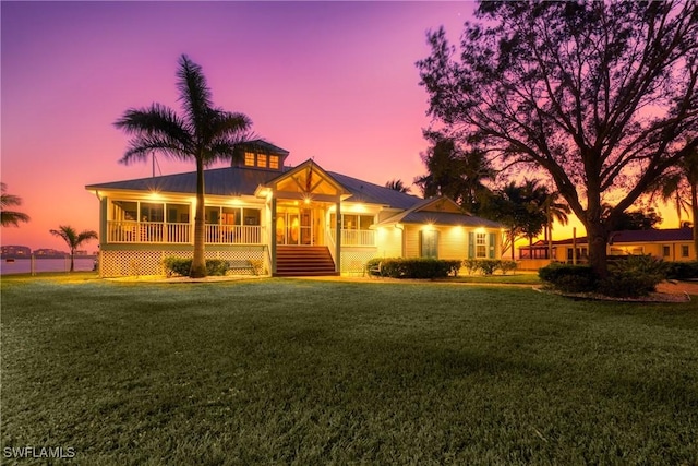 view of front of home featuring a porch and a yard