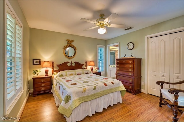 bedroom featuring ceiling fan, a closet, and light wood-type flooring