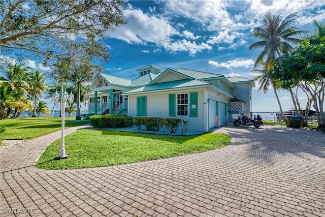 view of front facade with a porch, a garage, and a front yard