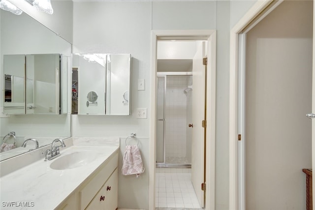 bathroom with tile patterned flooring, vanity, and an enclosed shower