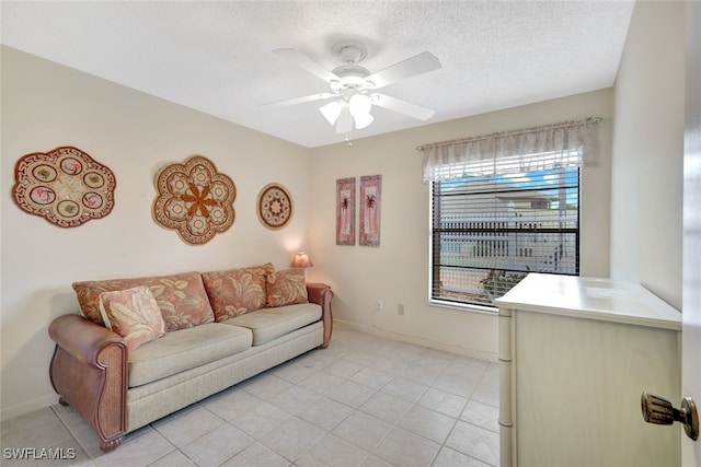 tiled living room featuring a textured ceiling and ceiling fan