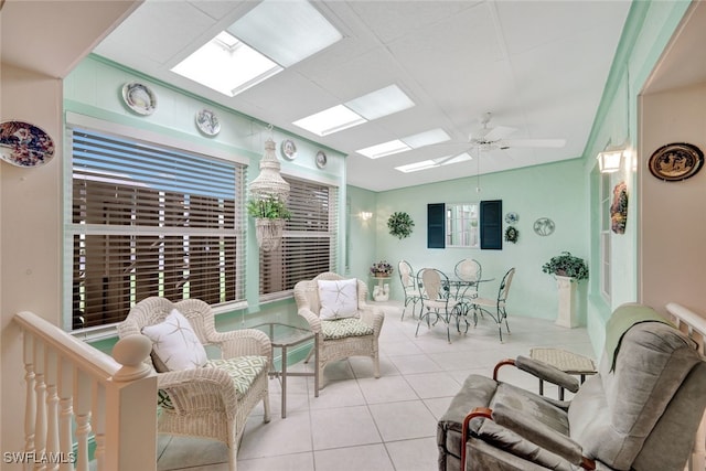 interior space with ceiling fan, light tile patterned flooring, and lofted ceiling