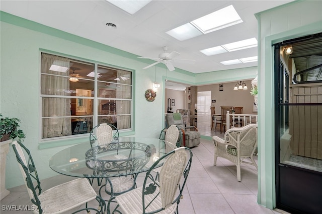 sunroom with ceiling fan with notable chandelier