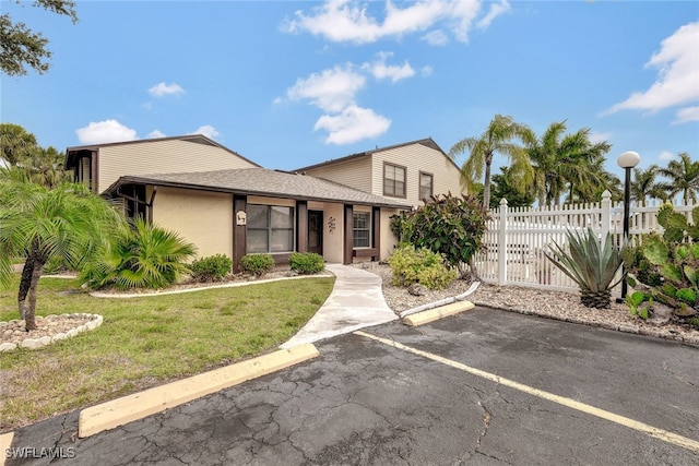 1204 SE 6th Ter Unit 67, Cape Coral, FL 33990 - view of front of home featuring uncovered parking, stucco siding, and roof with shingles