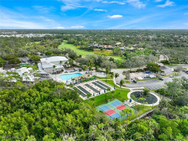 20916 Island Sound Cir Unit 104, Estero, FL 33928 - drone / aerial view of a pool area and a tree filled landscape