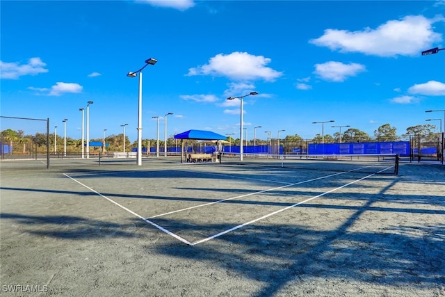 view of sport court featuring fence