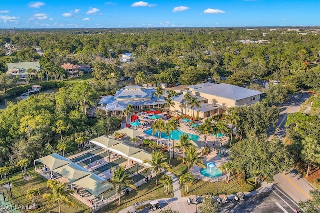 20916 Island Sound Cir Unit 104, Estero, FL 33928 - aerial view of property and surrounding area featuring a heavily wooded area and a pool area